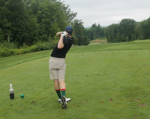 Golfer with some great socks teeing off